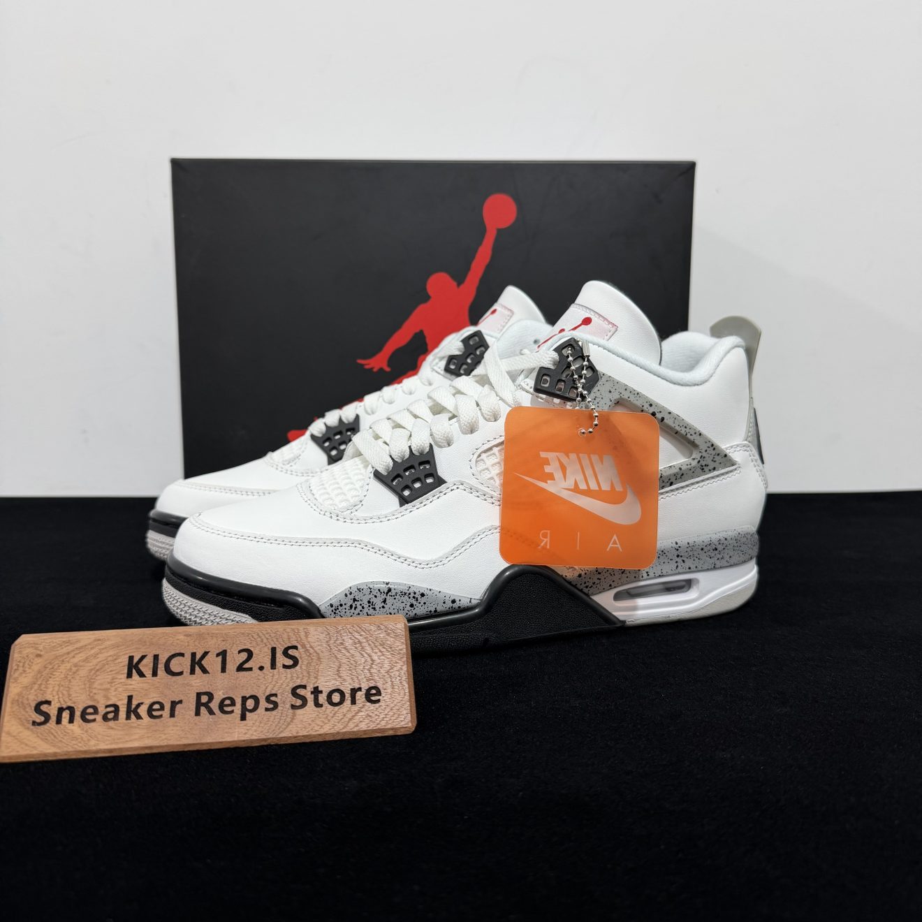 Jordan 4 White Cement 2025 Reps with box displayed on table