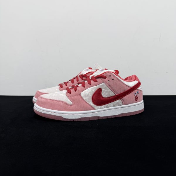 Side view of Strangelove Dunks Reps showing pink velvet upper